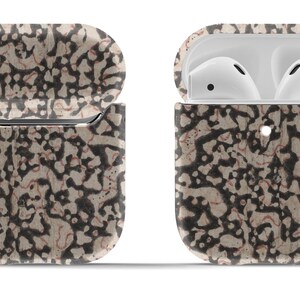 May include: A beige and black patterned protective case for AirPods with a silver metal keychain attached. The case is open to reveal the white AirPods inside.