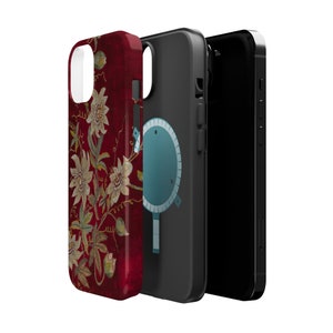 May include: A phone case with a floral design on a red background. The case is made of a hard plastic material and has a clear back. The phone case is shown with a black phone case on the right side.