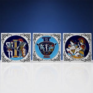 May include: Three square ceramic tiles featuring Greek-inspired illustrations. The left tile shows two figures by a column, the centre tile depicts a large amphora vase, and the right tile shows two figures labelled Patroclus and Achilles.