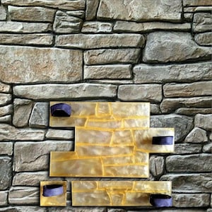 May include: A rectangular yellow polyurethane stamp mold featuring a raised stone wall pattern with recessed grout lines. The mold includes four dark blue fabric handles attached to the surface to facilitate lifting and repositioning during use.