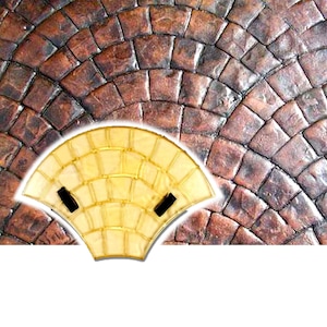 May include: A clear plastic mold for creating a fan-shaped pattern in concrete. The mold has a brown background and is made up of small squares.