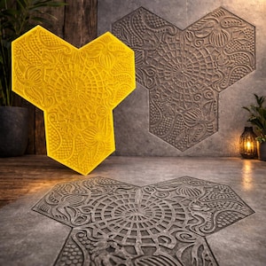 May include: A bright yellow, three-sided hexagonal tile featuring an intricate, embossed floral and geometric pattern. The surface displays a central circular mandala-like design surrounded by detailed paisley and botanical motifs in relief.
