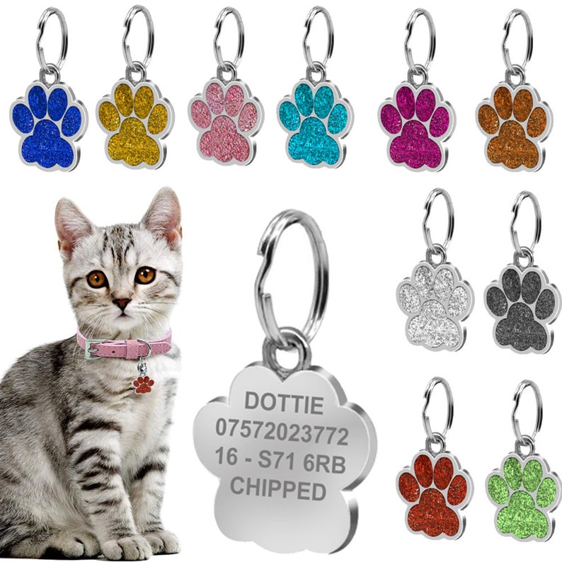 May include: A silver paw print pet ID tag with the text "DOTTIE 07572023772 16 - S71 6RB CHIPPED" engraved on it. The tag is attached to a silver key ring. The image also shows a variety of colourful paw print pet ID tags with glitter.