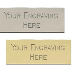 May include: Two rectangular metal plates, one silver and one gold, with the text "YOUR ENGRAVING HERE" engraved on each.