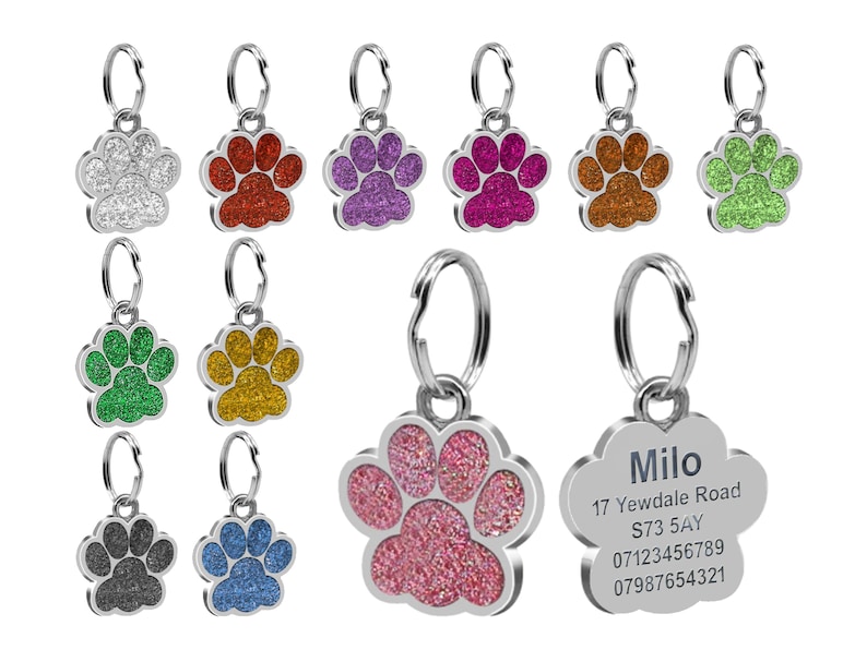 May include: Assortment of colorful glitter paw print dog tags with a silver metal ring. One tag has the name "Milo" and contact information.