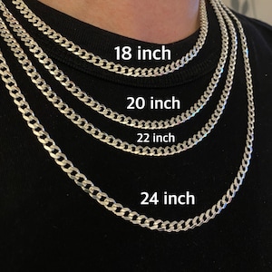May include: Four silver curb chain necklaces of different lengths, 18 inches, 20 inches, 22 inches, and 24 inches, are displayed on a person's neck.