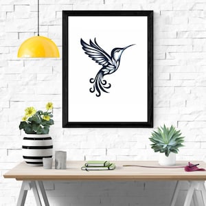 May include: A black framed print of a stylized hummingbird with a blue and white design. The hummingbird is flying with its wings spread out and its tail feathers are curled. The print is hanging on a white brick wall.