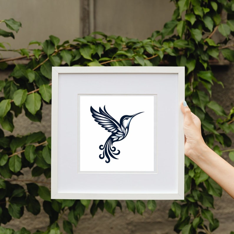 May include: A white frame with a black and white illustration of a hummingbird inside. The hummingbird is stylized with intricate details and a long, curved beak.
