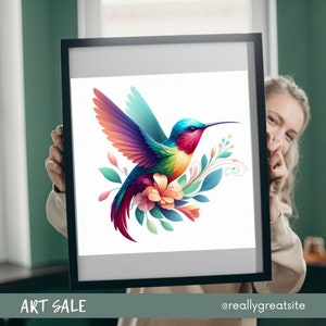 May include: A framed art print featuring a vibrant hummingbird with rainbow-colored wings, a red throat, and a long black beak. The bird is surrounded by flowers and leaves. The words "ART SALE" are at the bottom.