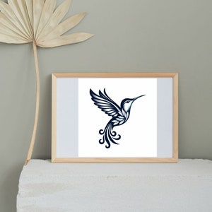 May include: A framed print of a stylized hummingbird in black and white with a blue gradient. The hummingbird is in flight with its wings spread and its tail feathers trailing behind it.
