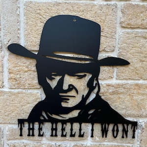 May include: Black metal wall art featuring a silhouette of a cowboy wearing a hat with the text "THE HELL I WON'T" below.