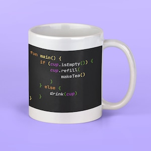 May include: White ceramic mug with a black background and code printed on it. The code reads: "fun main() { if (cup.isEmpty()) { cup.refill() makeTea() } else { drink(cup) } "
