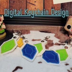 May include: Digital embroidery design for a keychain featuring four different colored gem shapes. The design is 4x4 inches and hoop friendly. The design files are available in DST, EXP, JEF, HUS, PCS, PEC, PES, VIP, VP3, and XXXX formats.
