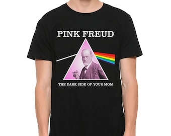 May include: Black t-shirt with the text "PINK FREUD" above a pink triangle featuring a portrait of Sigmund Freud. Below the triangle is the text "THE DARK SIDE OF YOUR MOM". A rainbow graphic is on the right side of the triangle.