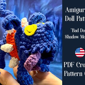 May include: Amigurumi doll crochet pattern for a blue, orange, white, and purple "Bad Doggy Shadow Monster". The pattern is a PDF download and is available in US English.