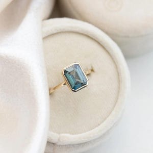 14K Yellow Gold Teal Sapphire Engagement Ring: Emerald Cut Bezel Set