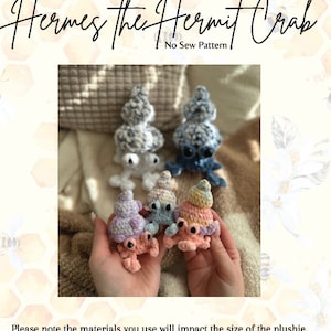 May include: Four crocheted hermit crab plushies in various colors, including pink, blue, white, and purple. The plushies are sitting in a person's hands. The image includes the text "Hermes the Hermit Crab" and "No Sew Pattern".