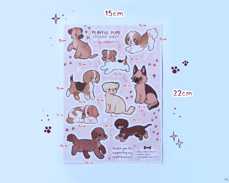 May include: A sticker sheet featuring nine playful puppy illustrations in various poses. The sheet is pink with white outlines and measures 15 cm by 22 cm. The text "Playful Pups Sticker Sheet" is at the top of the sheet, with the artist's name "by aoberri" below it.