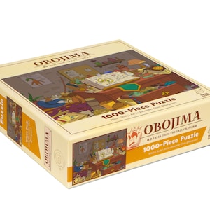 May include: A rectangular puzzle box with the word "OBOJIMA" in a bold font. The box features a colorful illustration of a room with various objects. The text "1000-Piece Puzzle" is also visible.