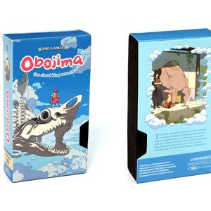 May include: Two blue game boxes. The front of the box features the title "Obojima the cloud king returns" with a cartoon illustration of a girl and a skeletal creature. The back of the box has an illustration of a bear and two people.