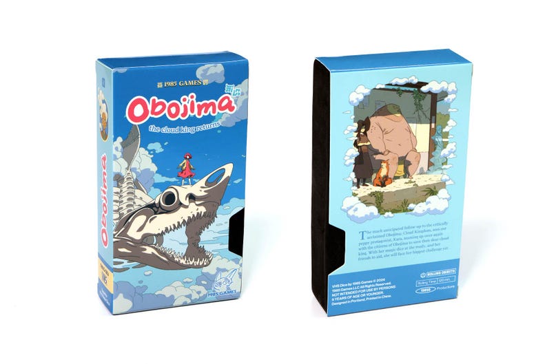 May include: Two blue game boxes. The front of the box features the title "Obojima the cloud king returns" with a cartoon illustration of a girl and a skeletal creature. The back of the box has an illustration of a bear and two people.
