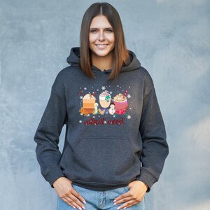 May include: A dark gray hoodie with a graphic of three winter drinks and the text "current mood".