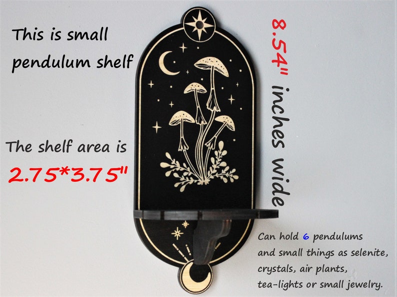 May include: Black wooden shelf with a crescent moon and stars design. The shelf is 8.54 inches wide and has a 2.75 by 3.75 inch shelf area. It can hold 6 pendulums and small items like selenite, crystals, air plants, tea lights, or small jewelry.