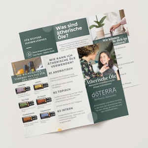May include: A brochure with the text "Was sind &auml;therische &Ouml;le?" and "Wie kann ich &auml;therische &Ouml;le verwenden?" is displayed. The brochure features images of essential oil bottles and people. The dōTERRA logo is visible.