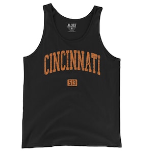 May include: Black tank top with the word "CINCINNATI" in distressed orange lettering. Below the word is the number "513" in a rectangular box. The tank top has a classic athletic style and is made of a soft material.
