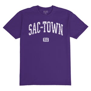 Puede incluir: Camiseta morada con texto blanco que dice "SAC-TOWN 916".