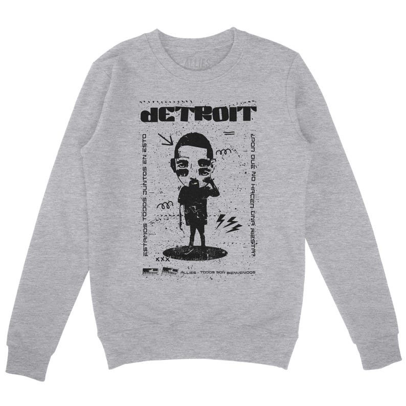 Peut inclure: Un sweat &agrave; manches longues gris avec un imprim&eacute; graphique noir d'un personnage de dessin anim&eacute; avec le mot "DETROIT" au-dessus. Le texte sous le dessin anim&eacute; dit "ESTAMOS TODOS JUNTOS EN ESTO" et "&iquest;POR QUE NO HACER UNA FIESTA?"