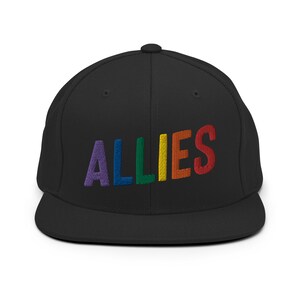 May include: A black, flat-brimmed baseball cap with the word "ALLIES" embroidered in rainbow colors.
