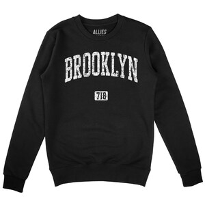 May include: Black sweatshirt with a white vintage-style graphic that says "BROOKLYN 718" with the word "ALLIES" printed in white on the neck.