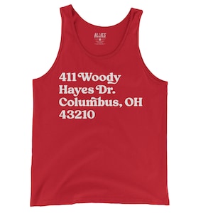 May include: Red tank top with white text that reads "411 Woody Hayes Dr. Columbus, OH 43210"
