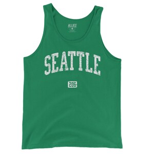 May include: A green tank top with a white distressed graphic that says "SEATTLE 206".