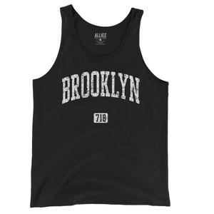 May include: Black tank top with a white vintage-style graphic that says "BROOKLYN 718".
