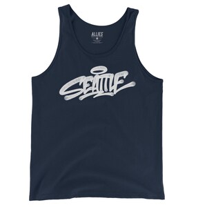 May include: A navy blue tank top with a white graphic of the word "SEATTLE" in a graffiti style with a halo above the "E". The word "ALLIES" is printed on the tag.