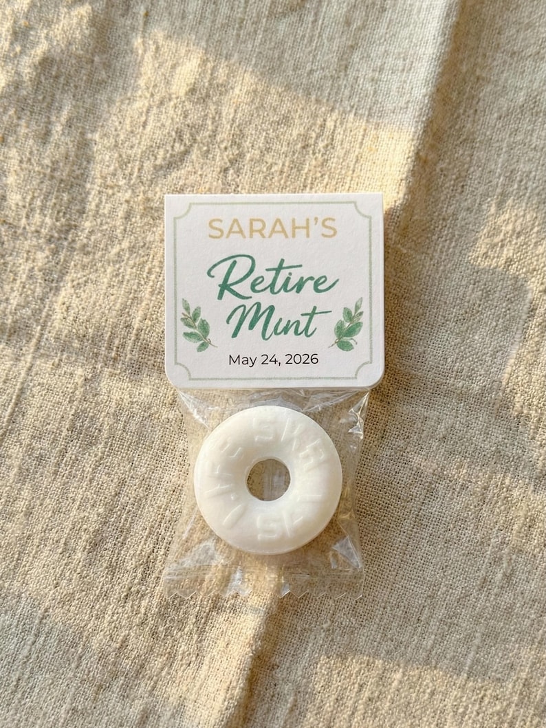 May include: A small cellophane bag containing a white mint candy with a hole in the center. The bag is attached to a small card that reads "SARAH'S Retire Mint" in green script, with the date "May 24, 2026" below.
