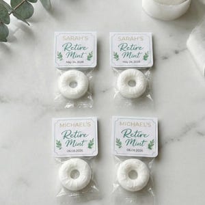 May include: Four individually packaged mints with tags that read "Retire Mint." Two are labeled "Sarah's" with the date "May 24, 2026," and two are labeled "Michael's" with the date "06.08.2026." The mints are white and donut-shaped.