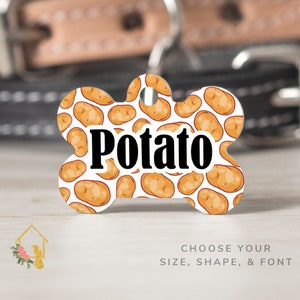 May include: White bone-shaped dog tag with a potato print pattern and the word "Potato" in black text.