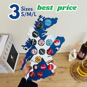May include: A wooden map of Scotland in blue and white, adorned with beer bottle caps. The map is held by a person. The text "3 Sizes S/M/L best price" is at the top. The map has several bottle caps attached.