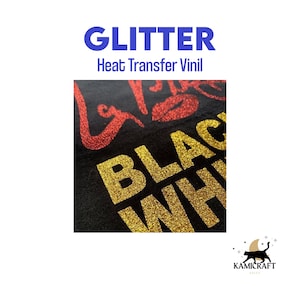May include: Close-up of gold glitter heat transfer vinyl applied to black fabric. The vinyl spells out "BLACK" and part of "WHITE".