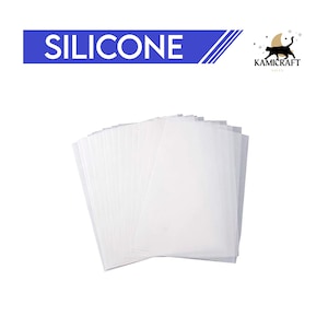 May include: A stack of white silicone baking sheets. The sheets are translucent and have a smooth surface. The sheets are used for baking and cooking.