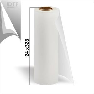 May include: A roll of white transfer film, 24 inches by 328 inches, for DTF printing. The roll is cylindrical with a brown core and a partially unrolled sheet extending from the side. The DTF PARTS.com logo is visible in the upper left corner.