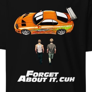 May include: Black t-shirt featuring an orange sports car graphic above two figures walking away. The text "Forget About It, Cuh" is printed in white at the bottom. The car has green and white accents.