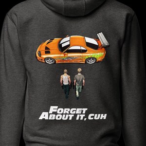 May include: Dark gray hoodie featuring an orange sports car graphic with a rear spoiler, and two figures walking away. Below the graphic is the text "FORGET ABOUT IT, CUH" in white.