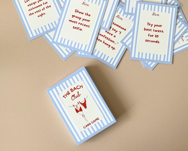 May include: A card game called "The Bach Club" with a light blue and white striped design. The card game features a red bikini graphic and the words "CARD GAME". Individual cards with "Dare" prompts are scattered around, including "Try your best twerk for 10 seconds."