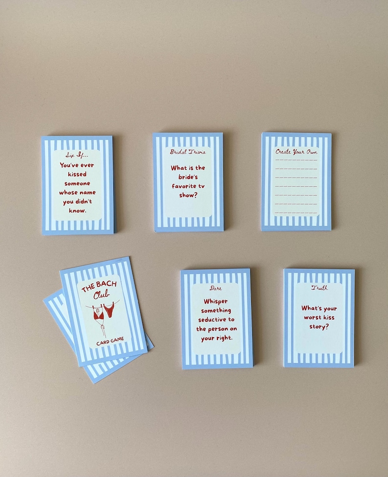May include: A set of blue and white striped cards with red text, designed for a game. The cards feature prompts such as "What is the bride's favourite TV show?" and "Whisper something seductive to the person on your right."