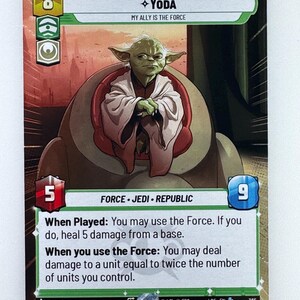 May include: A Star Wars trading card featuring Yoda. The card has a green and white border with the word "Yoda" and the text "My ally is the Force." Yoda is depicted in a seated position. The card also includes game information.