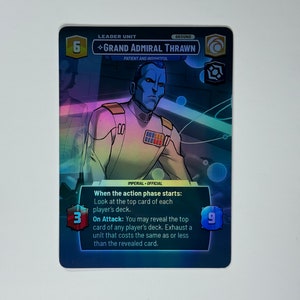 May include: A blue and white Star Wars collectible card featuring Grand Admiral Thrawn, a leader unit with a power of 6 and a ground symbol. The card text reads "When the action phase starts: Look at the top card of each player's deck. On Attack: You may reveal the top card of any player's deck. Exhaust a unit that costs the same as or less than the revealed card."